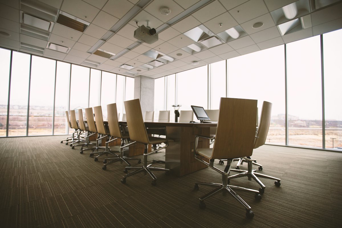 An empty boardroom with an oval wooden table