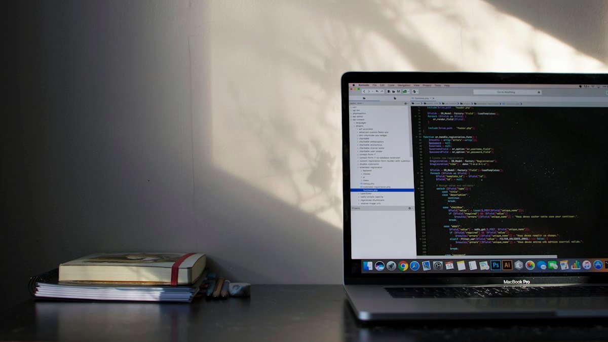 A MacBook Pro showing code