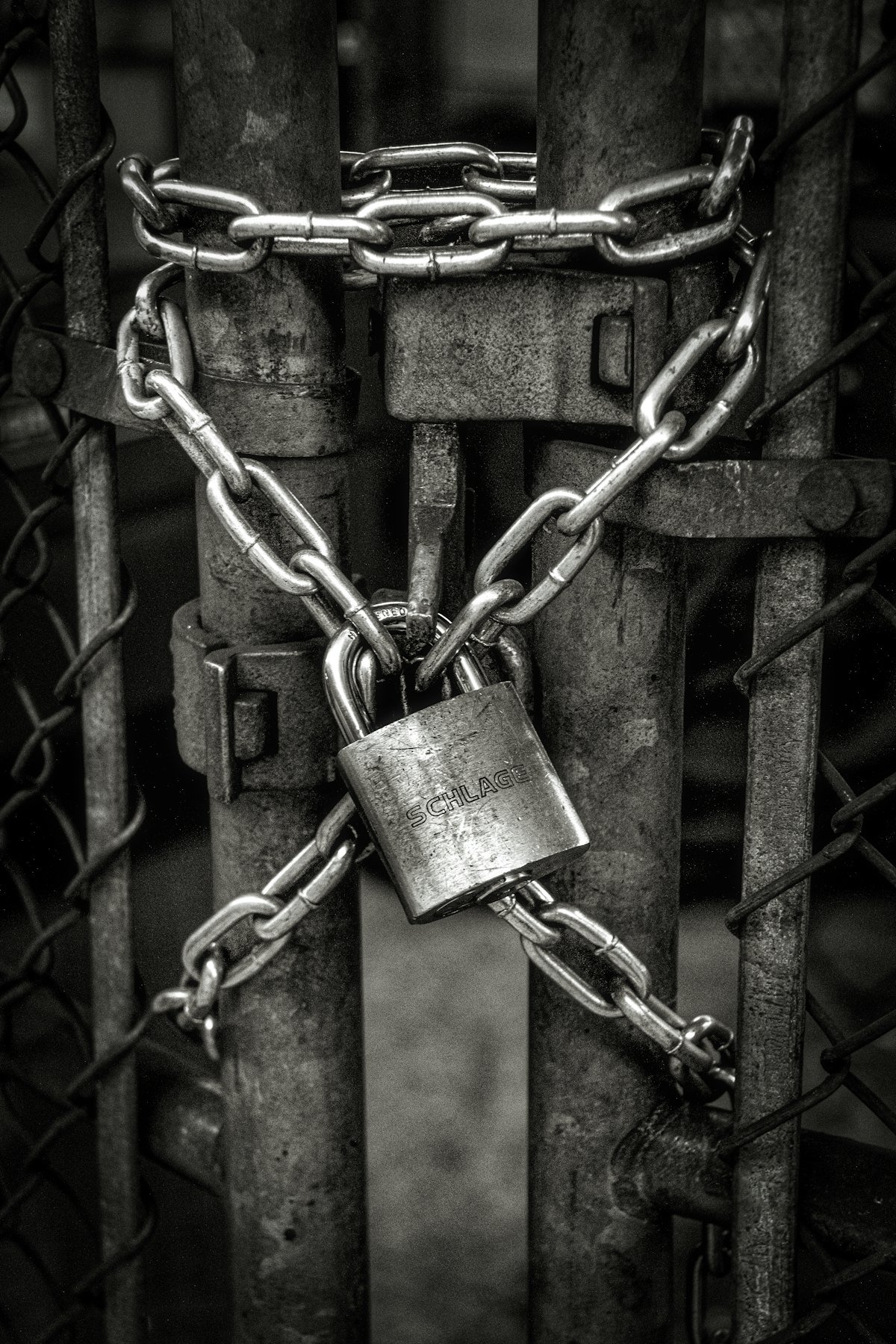 Gray steel chain locked on gate
