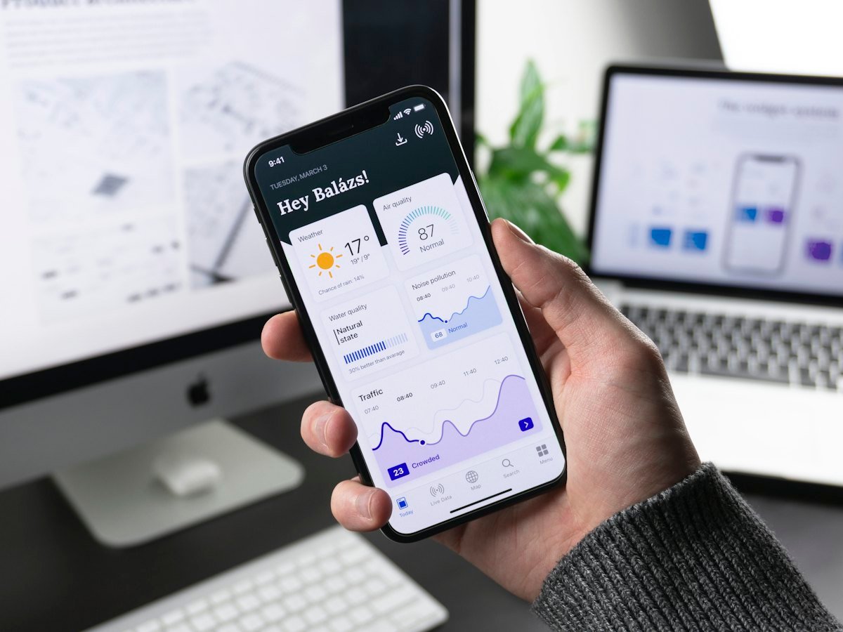 A smartphone showing a dashboard of weather and traffic data