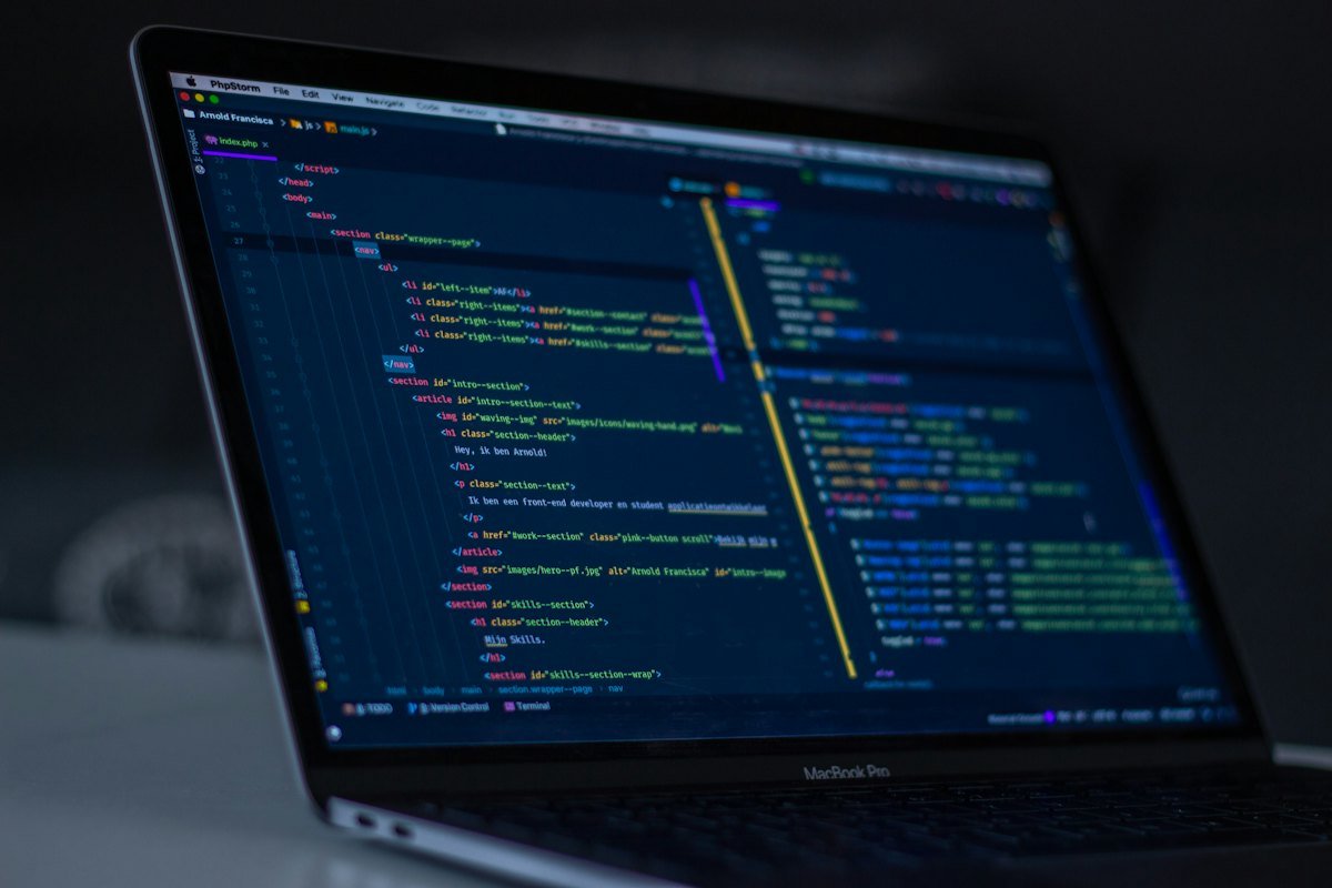 A MacBook Pro displaying code