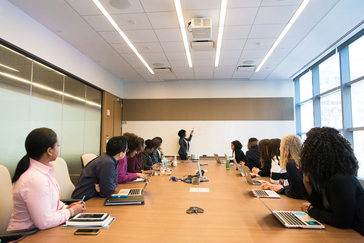 A team at a conference table listening to a colleague