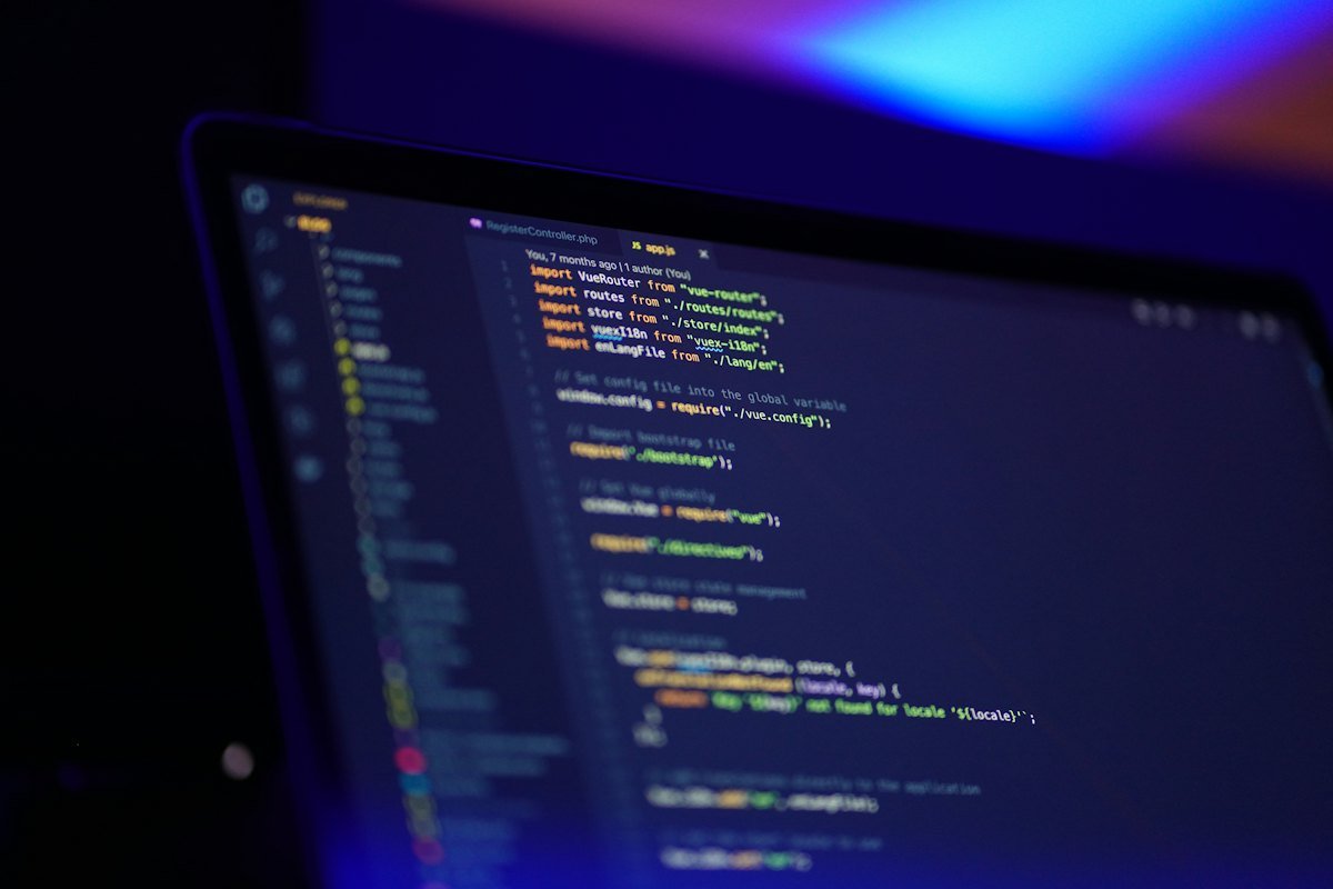 A laptop screen showing colourful code