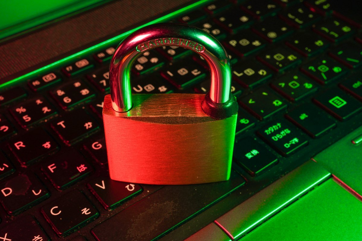 A red padlock resting on a black keyboard