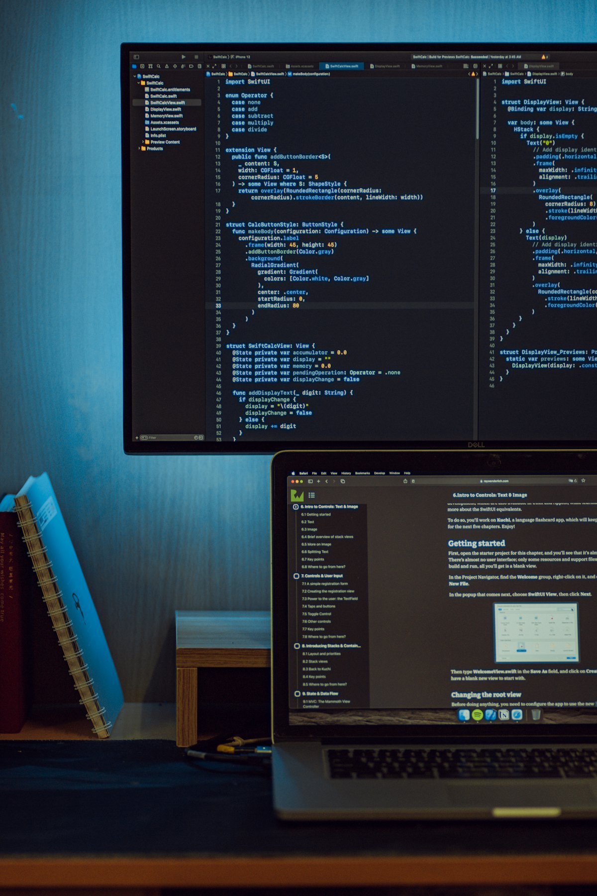A monitor and laptop showing code