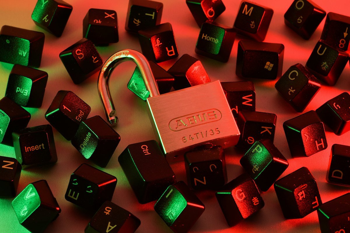 An open padlock among scattered keyboard keys