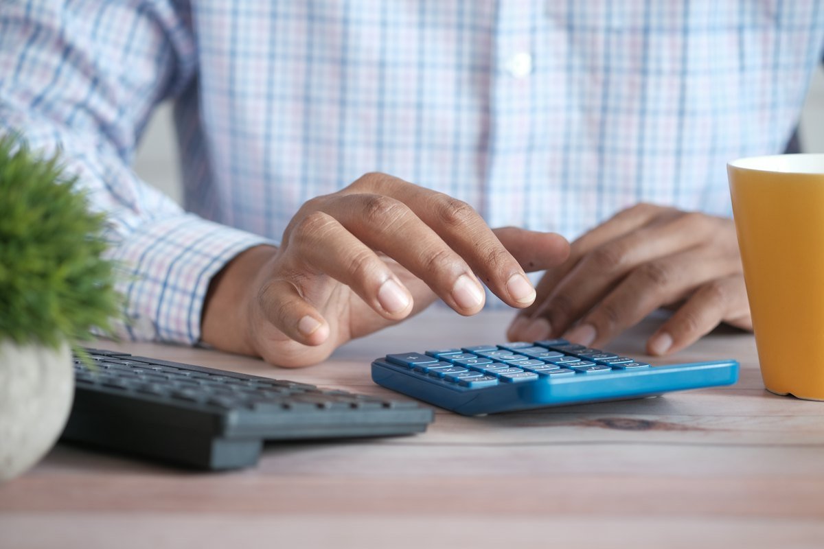 A person using a calculator at a desk