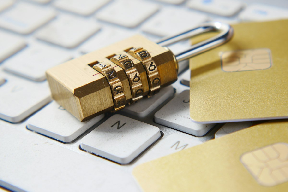 A brass padlock sitting on a keyboard