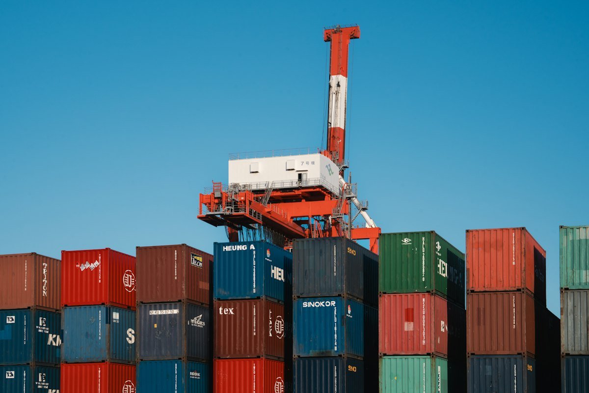 A crane above a stack of shipping containers