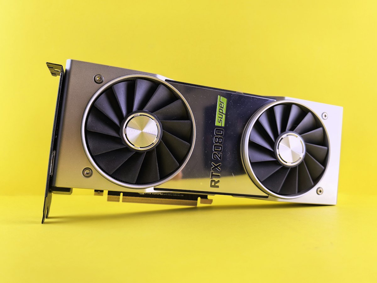 A close-up of a graphics card on a yellow background