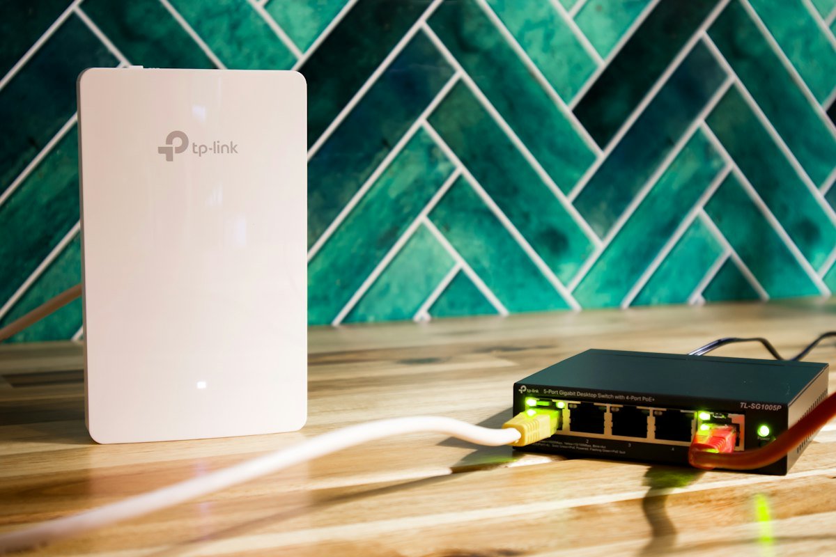A wi-fi router beside a network switch